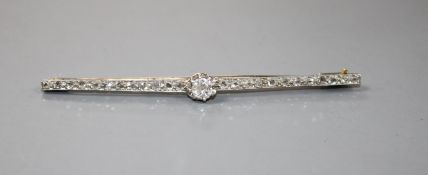 A 1920's yellow and white metal, diamond bar brooch, with central old cut diamond and millegrain set