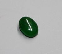 An unmounted cabochon cut jadeite stone, with GCS certificate dated 25/02/20, stating the stone to