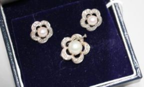 A modern 18ct white gold, cultured pearl and diamond set suite of jewellery, of pierced flower