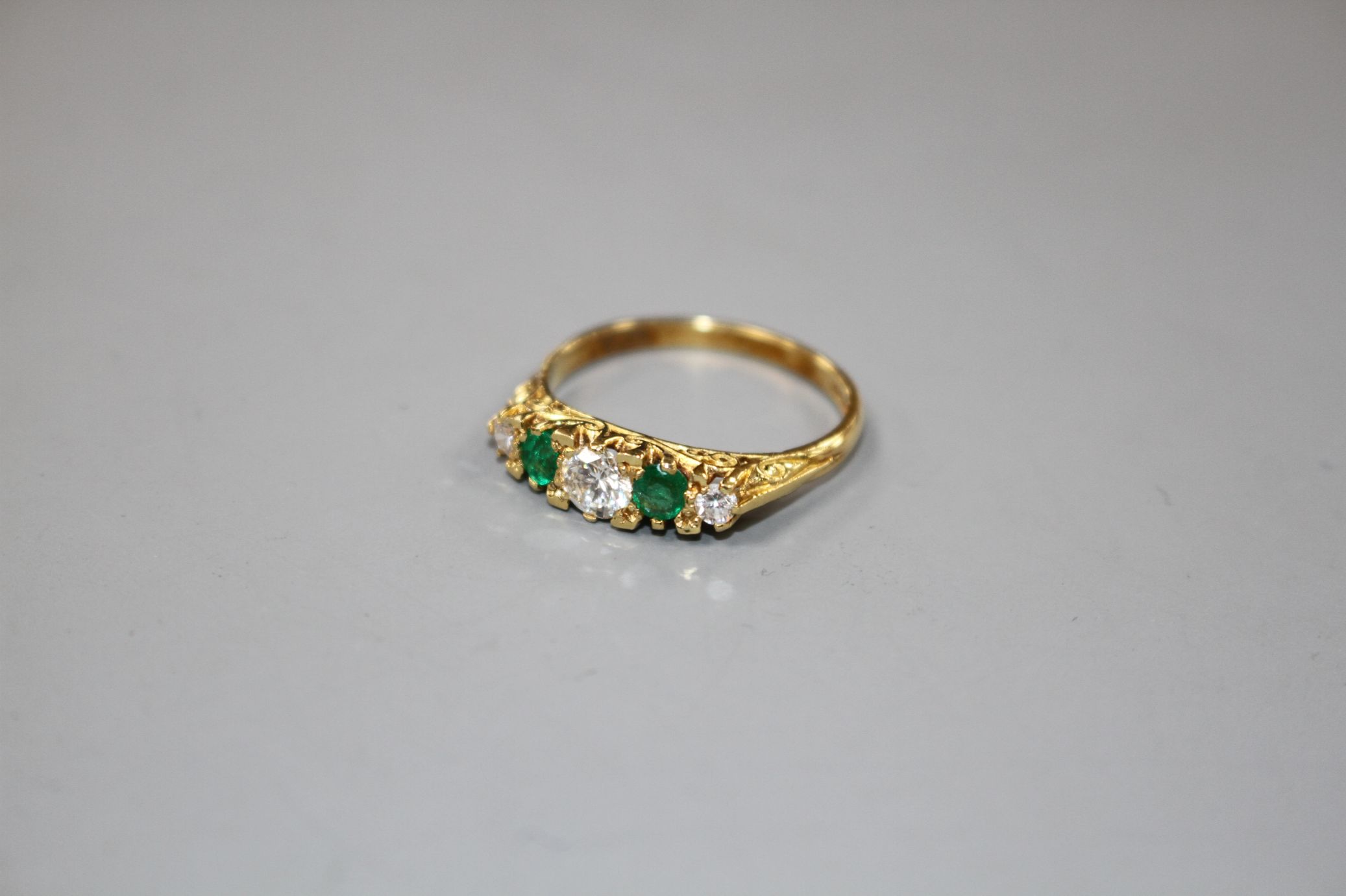 A modern Victorian style 18ct gold, two stone emerald and three stone diamond set half hoop ring, - Image 2 of 5