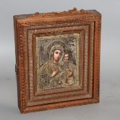 A late 19th century Russian tempera on panel icon, with silver gilt oklad dated 1889, housed in an