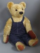A large Chad Valley 1950's bear, in blue dungarees, 27in., good condition with new paw pads
