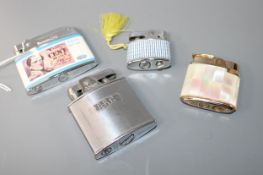 Four assorted lady's and gentleman's base metal cigarette lighters including Ronson mother of