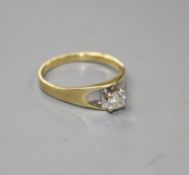 A modern 18ct gold and solitaire diamond ring, size L/M, gross weight 2.6 grams.Condition- Mildly