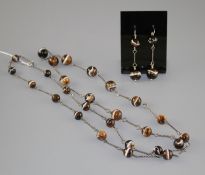 A white metal and graduated banded agate bead long necklace and pair of matching earrings,