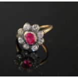 A yellow and white metal, ruby and diamond set oval cluster ring, (adapted), with GCS certificate (
