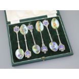 Six white metal and enamel teaspoons, decorated with Nairobi safari scenes with animals, unmarked,