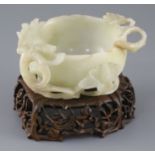 A Chinese pale celadon jade 'lotus' cup, late Ming dynasty, the cup formed as a lotus flower