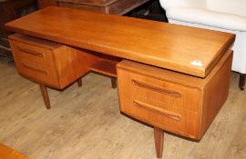 A 1950's G-Plan teak dressing table, fitted five drawers, W.152cm D.46cm H.70cm Condition: A