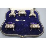 A cased George V silver five piece condiment set, Robert Pringle & Sons, London, 1935 and one spoon,