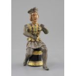 An Austro-Hungarian gilt and white metal figure of a seated knight, with jewelled decoration and