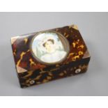 A late 19th century Swiss gold mounted tortoiseshell musical box, inset with a miniature of a