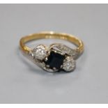 A modern 18ct gold, sapphire and illusion set diamond three stone crossover ring, size L, gross