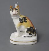 A rare Staffordshire porcelain figure of a seated cat, c.1835-50, both ears restored (one reglued)