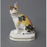 A rare Staffordshire porcelain figure of a seated cat, c.1835-50, both ears restored (one reglued)