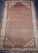 A Persian russet ground rug with central field of leaf motifs, multi-bordered, 150 x 95cm Condition: