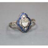 A mid 20th century yellow metal (stamped 9ct?, blue and white paste set quatrefoil shaped ring, size