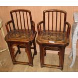 A pair of Chinese elm wood chairs, W.44cm D.33cm H.68cm Condition: One chair slightly smaller in
