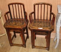 A pair of Chinese elm wood chairs, W.44cm D.33cm H.68cm Condition: One chair slightly smaller in