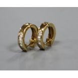 A pair of modern 750 yellow metal and seven stone baguette cut diamond set half hoop earrings,