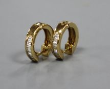 A pair of modern 750 yellow metal and seven stone baguette cut diamond set half hoop earrings,