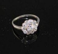 A white metal and eleven stone diamond circular cluster ring, size K, gross weight 3.1 grams.