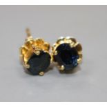 A pair of yellow metal (stamped 18k) and solitaire oval cut sapphire set eat studs, sapphires