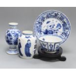 A Chinese blue and white tea bowl and saucer and two jars, Kangxi, some damage largest diameter