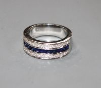 A modern 750 white metal sapphire and diamond set three row half eternity ring, size M, gross 9.2
