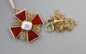 An early 20th century Russian 56 zolotnik yellow metal and enamel cross pendant and an associated