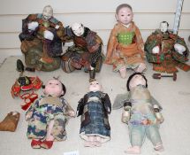 A collection of Japanese lacquered and composition head Gosha dolls, including three Musha