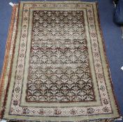 An Antique Persian black ground rug, with field of stylised floral motifs, multi-bordered, 141 x