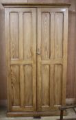 An Edwardian pitched pine hall cupboard, with two panelled doors enclosing two fixed shelves and