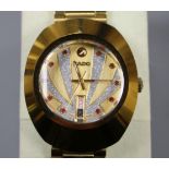 A gentleman's gilt steel Rado Diastar day/date automatic wrist watch, with red stone set markers and