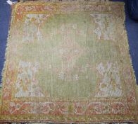 An Antique Turkestan square mat, with central green and red medallion, 108 x 121cm Condition: