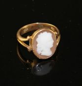 An early 20th century 18ct and oval cameo set dress ring, carved with the head of a lady to
