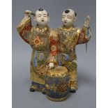 A Satsuma pottery group of two boys drumming height 28cm