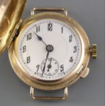 A lady's 1930's yellow metal (stamped 9c) 'Golfball?' manual wind wristwatch, with hinged cover,