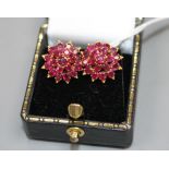 A pair of yellow metal and ruby cluster set flower head earrings, 13mm, gross weight 4.9 grams.