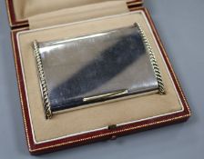 A George VI Cartier silver and yellow metal mounted cigarette case, in original fitted Cartier