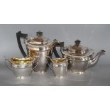 A silver plated four piece tea set, with an associated pair of plated sugar tongs Condition: Needs a