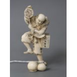 A Japanese carved ivory figure of an entertainer startled by a rat, late Meiji period, signed,