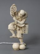 A Japanese carved ivory figure of an entertainer startled by a rat, late Meiji period, signed,