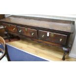 A George III banded oak low dresser, W.188cm D.51cm H.77cm Condition: Of rich dark oak tone, with