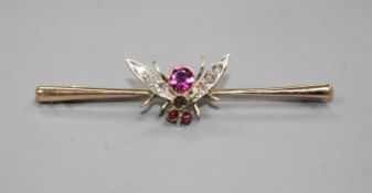 A Victorian 9ct, garnet and diamond set bug bar brooch, 54mm, gross weight 3.3 grams. Condition: