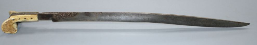 A Turkish sword Yataghan, with silver inlaid decoration and inscription, ivory grips, overall length