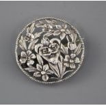 A late Victorian pierced white metal brooch, decorated with central mask amid foliage, makers mark