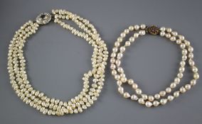 A double strand cultured baroque pearl necklace with yellow metal and garnet ? cluster clasp and one