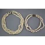 A double strand cultured baroque pearl necklace with yellow metal and garnet ? cluster clasp and one