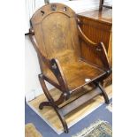 A 17th century style oak bishop's chair, with relief carved lion rampant crest, W.70cm D.58cm